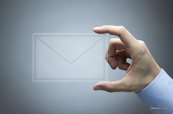 Human hand holding futuristic transparent mail icon