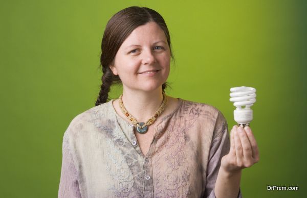 an environmentalist holds a compact fluorescent light bulb