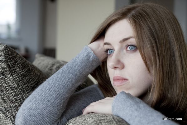 sad woman sitting on the bed