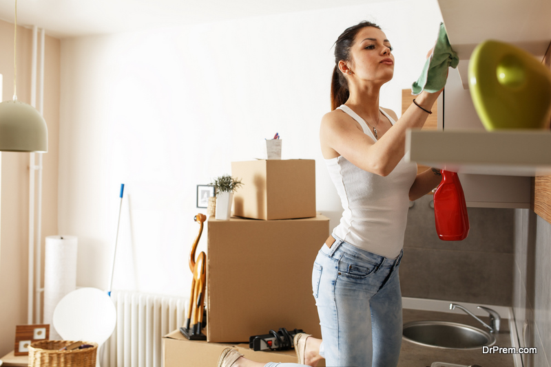 Young female cleaning her new apartment.Moving house concept.